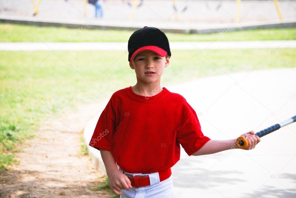 Little baseball player holding bat