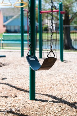 A swing at empty playground clipart