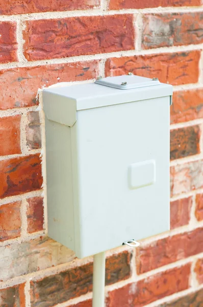 Electric control box on red brick wall — Stock Photo, Image