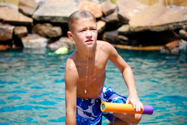 Boy getting out of swimming pool — Stock Photo, Image