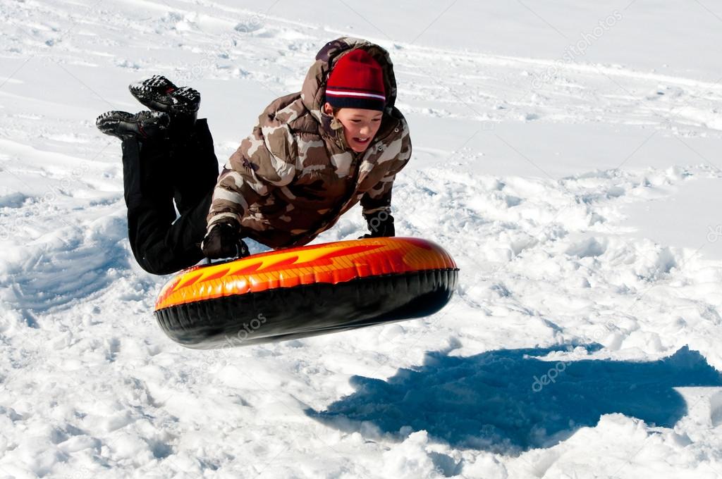 Boy tubing in the snow