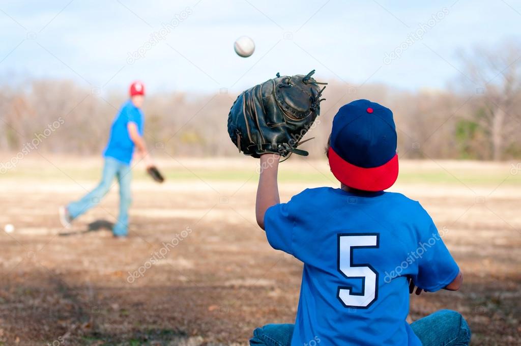 Two boys playing baseball at the park