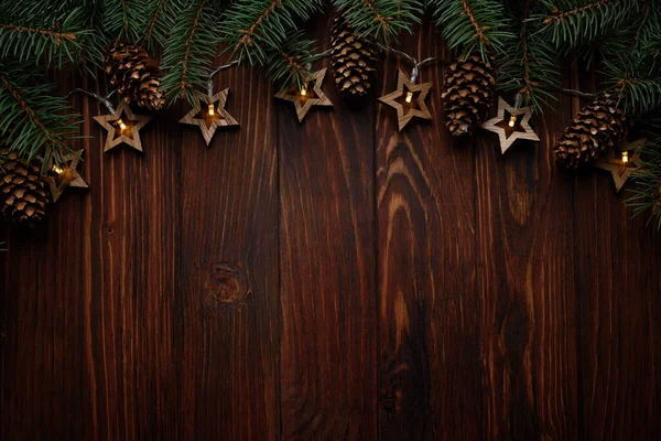 Karácsonyi Háttér Fenyő Ágak Kúpok Csillag Alakú Lámpák Sötét Fórumon — Stock Fotó