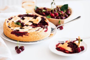 Plate with tasty American cherry pie on white background. Top view. Copy space