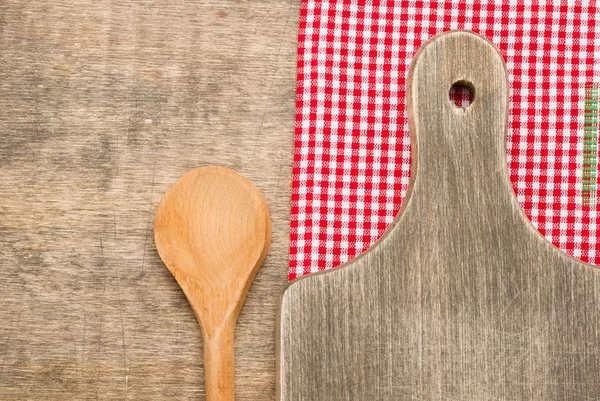 Wooden spoon and cutting board — Stock Photo, Image