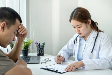 Hasta, teşhis ve reçete yazarken ve kliniğinde kendisine tavsiye verirken doktordan gelen hastalık ve semptomları dinlerken stres altındadır ve elde tutulur.