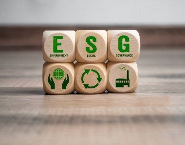 Cubes, dice or blocks with acronym ESG environment social governance on wooden background clipart
