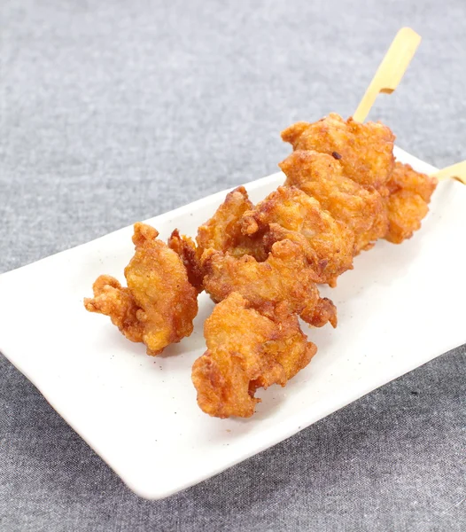 Fried chicken with skewer on