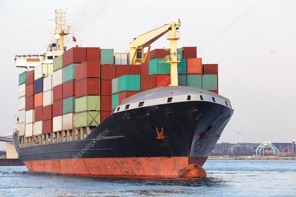 Cargo freight ship with stacked container at harbor terminal