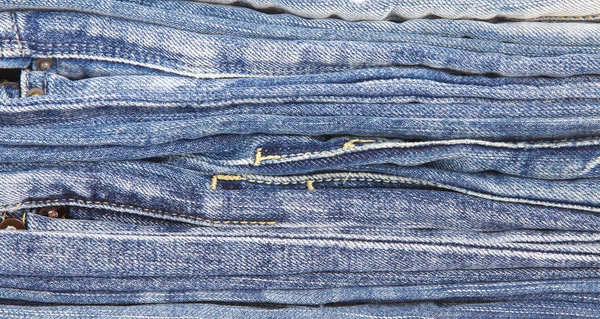 Lot of different blue jeans — Stock Photo, Image