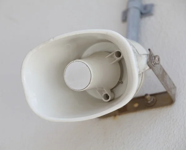 Old white loudspeaker on wall — Stock Photo, Image