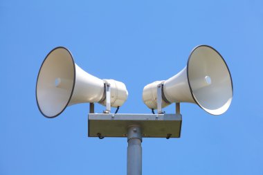 Loud speaker on blue sky clipart