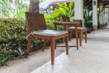 Boş kahverengi ahşap masa ve sandalye binanın koridorunda oturma ve dinlenme için hazır.