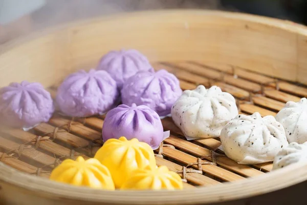 Close-up of colorful stuffed steamed bun, thai street food market