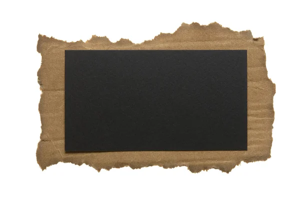 Ripped piece of cardboard with paper note isolated on white — Stock Photo, Image