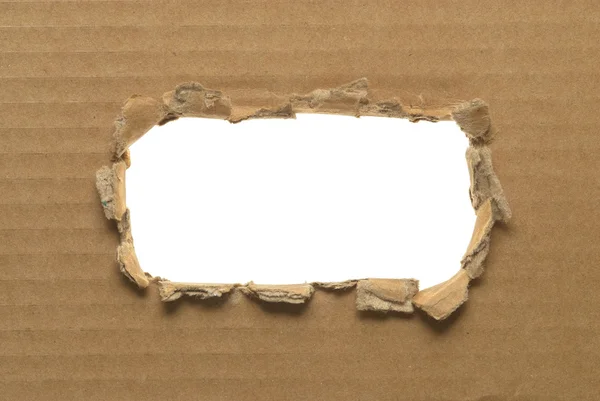 Ripped hole in cardboard on white background — Stock Photo, Image