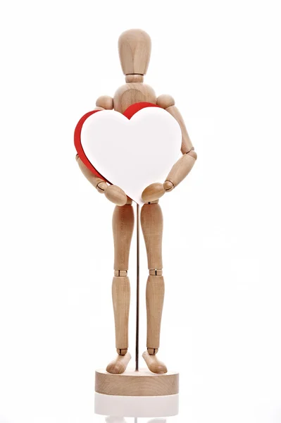 Bambola di legno tiene carta a forma di cuore — Foto Stock