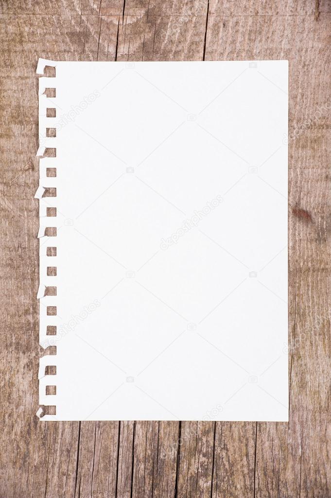 Sheet of paper on wooden background