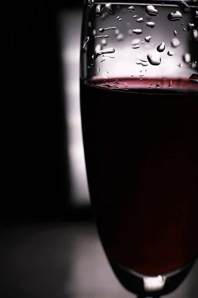 glass of red wine on dark background