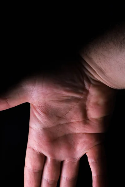 hand of a person on a black background