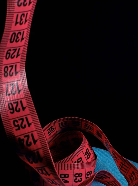 colorful measuring tapes on a black background