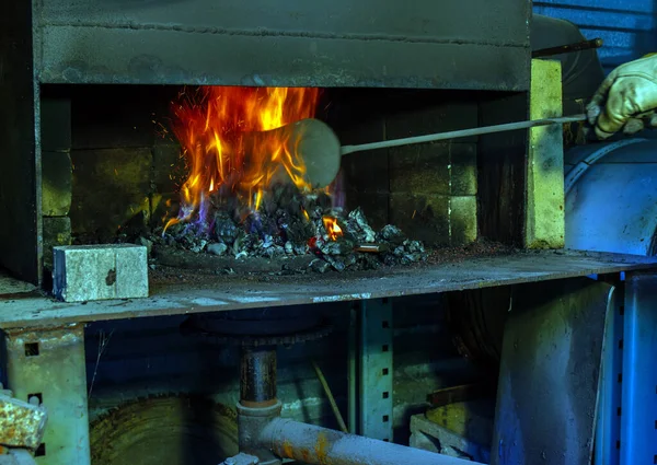 有才华的铁匠用金属铲子搅拌煤炉内的火苗 这种热量很快就会被用于手工制作刀具的工艺中 Bokeh — 图库照片