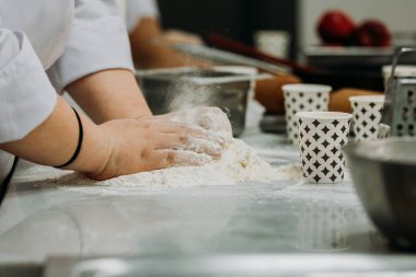 A gastronomy student making dough for Apple Pie