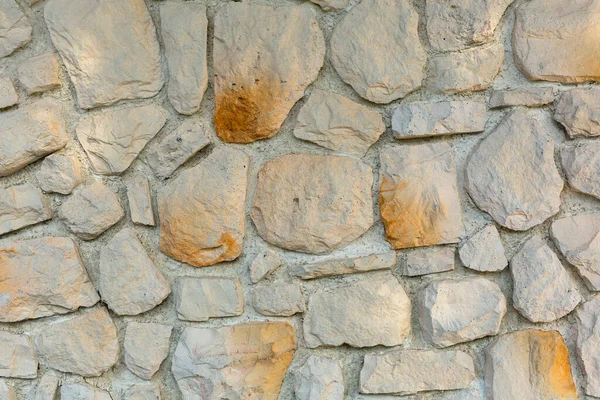 The texture of the stone wall. Background texture of the stone wall of the old building. Stone wall as background or texture