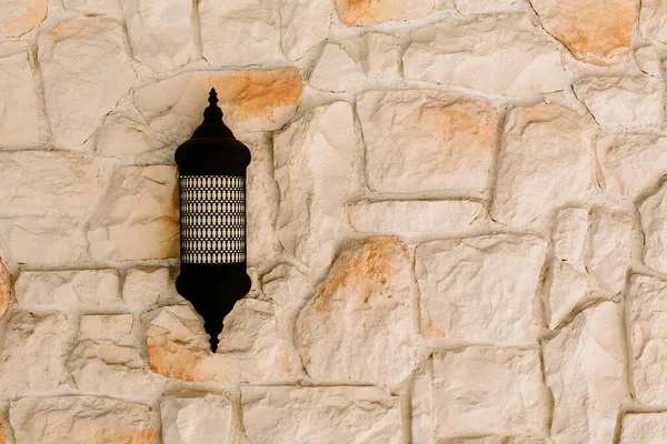 The texture of a stone wall.  Sconce and Stone wall as background or texture