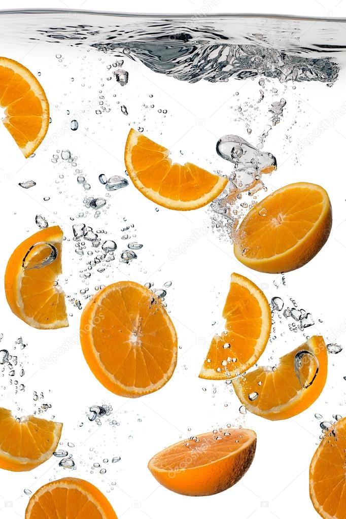 Healthy Water with Fresh Oranges. Splash isolated on white