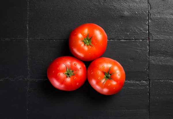 Fresh and Health Tomatoes over Black Slate — Stock Photo, Image