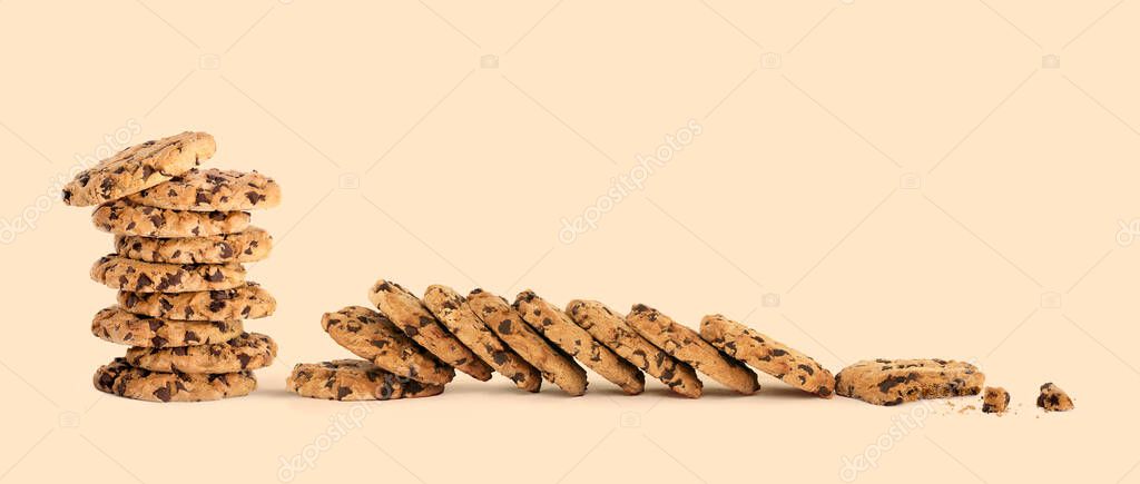 Banner with lots of delicious freshly baked crunchy homemade chocolate chip cookies on a creamy color background with copyspace