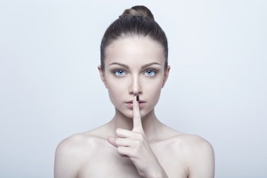 Young woman with finger on lips clipart
