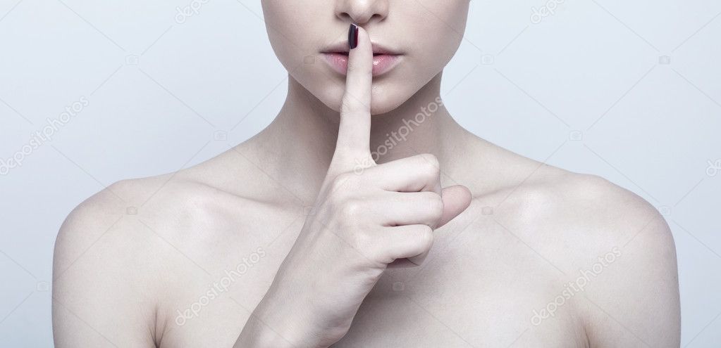 Woman with finger on lips
