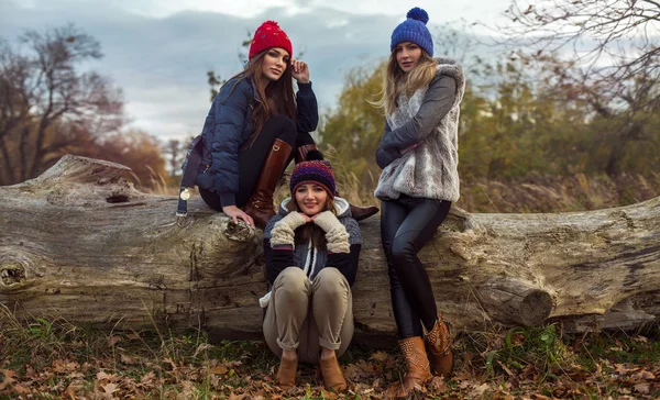 Happy tree girls wearing a woolly hats