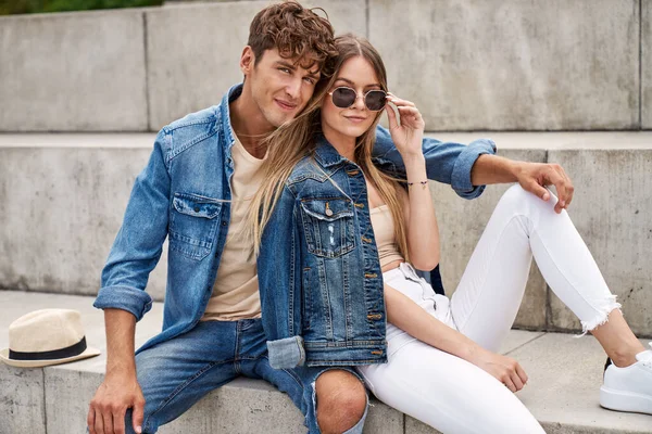 Photo Attractive Couple Wear Denim Clothes Sitting Outdoor Looking Camera — Stock Photo, Image