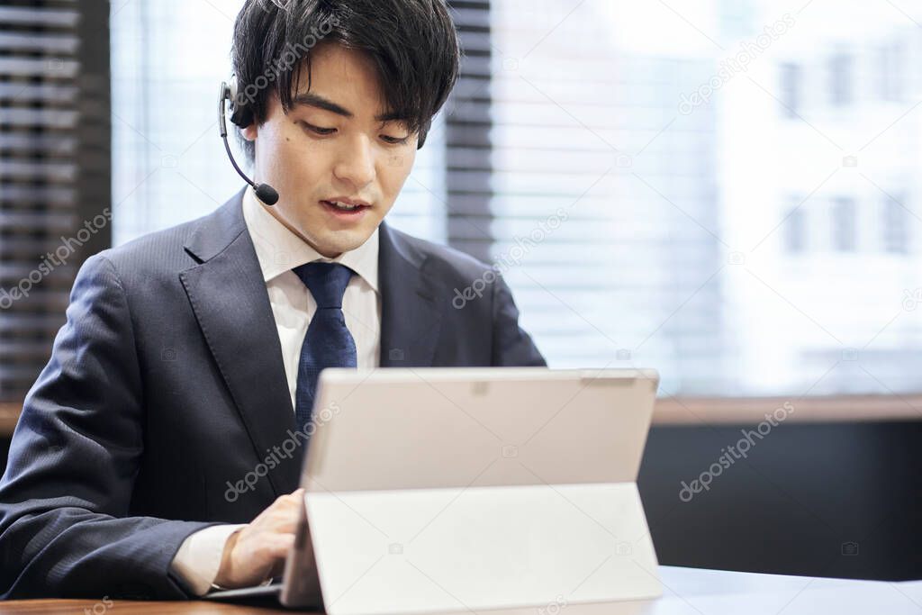 Asian business person responding at the customer center