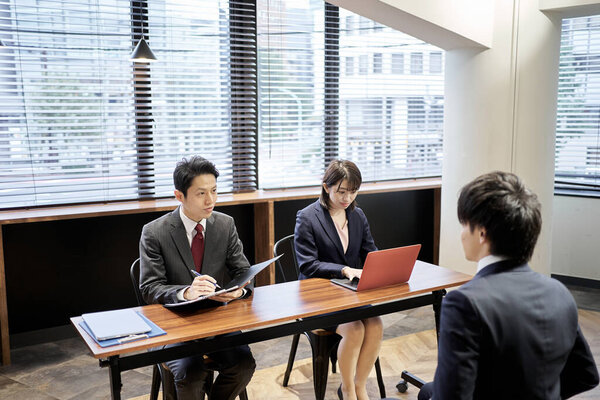 Asian managerial business person interviewing