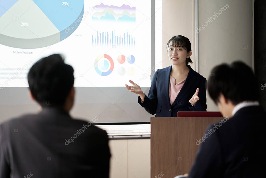 Asian business woman presenting at a conference