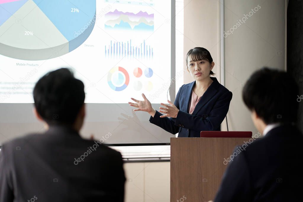 Asian business woman presenting at a conference