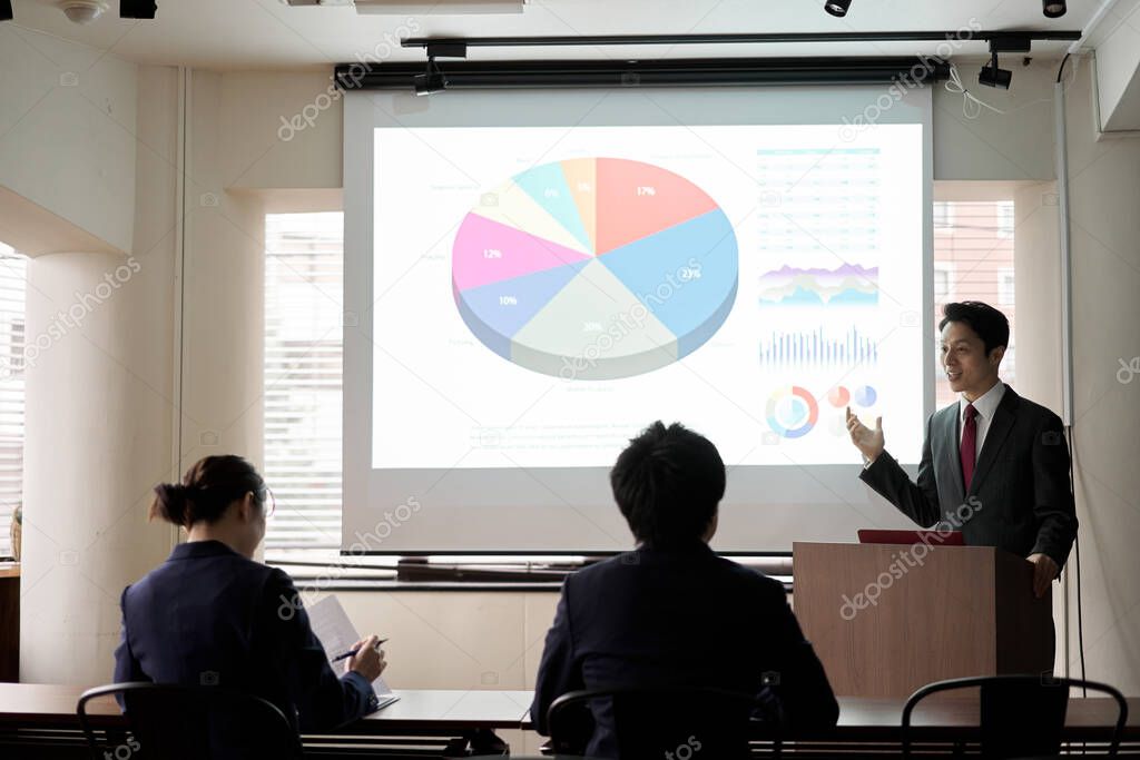Asian businessman giving a presentation at a conference