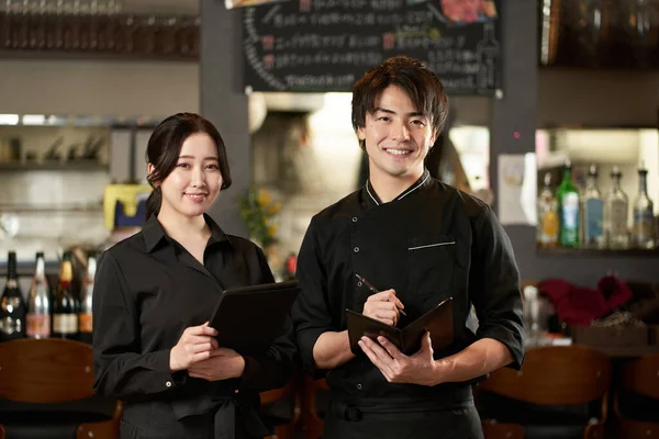 Asian men and women working in restaurants