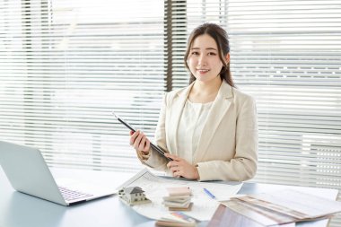Asian female architect standing at a design office