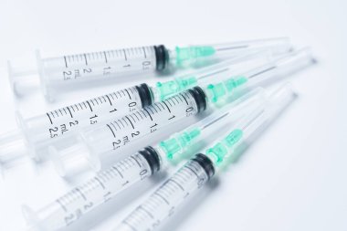 Multiple syringes placed on a white background