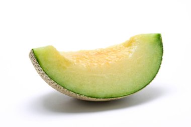 Earl's melon cut in quarters, photographed against a white background