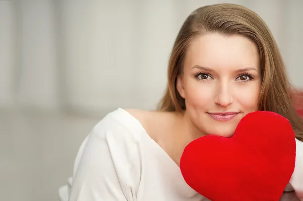 Beautiful woman holding heart in hand - care and love — Stock Photo, Image