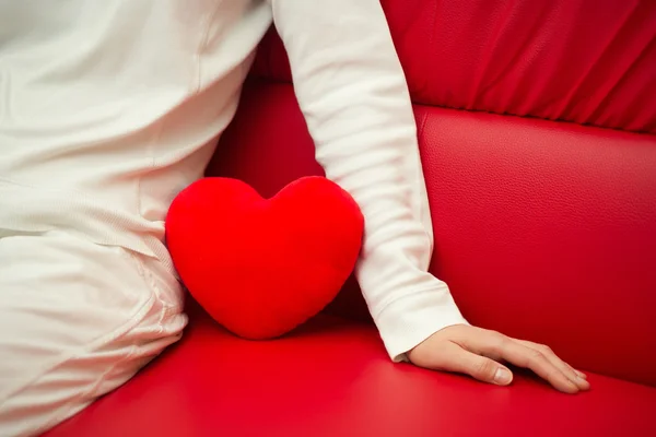 Lonely heart on sofa - Valentine and loneliness — Stock Photo, Image