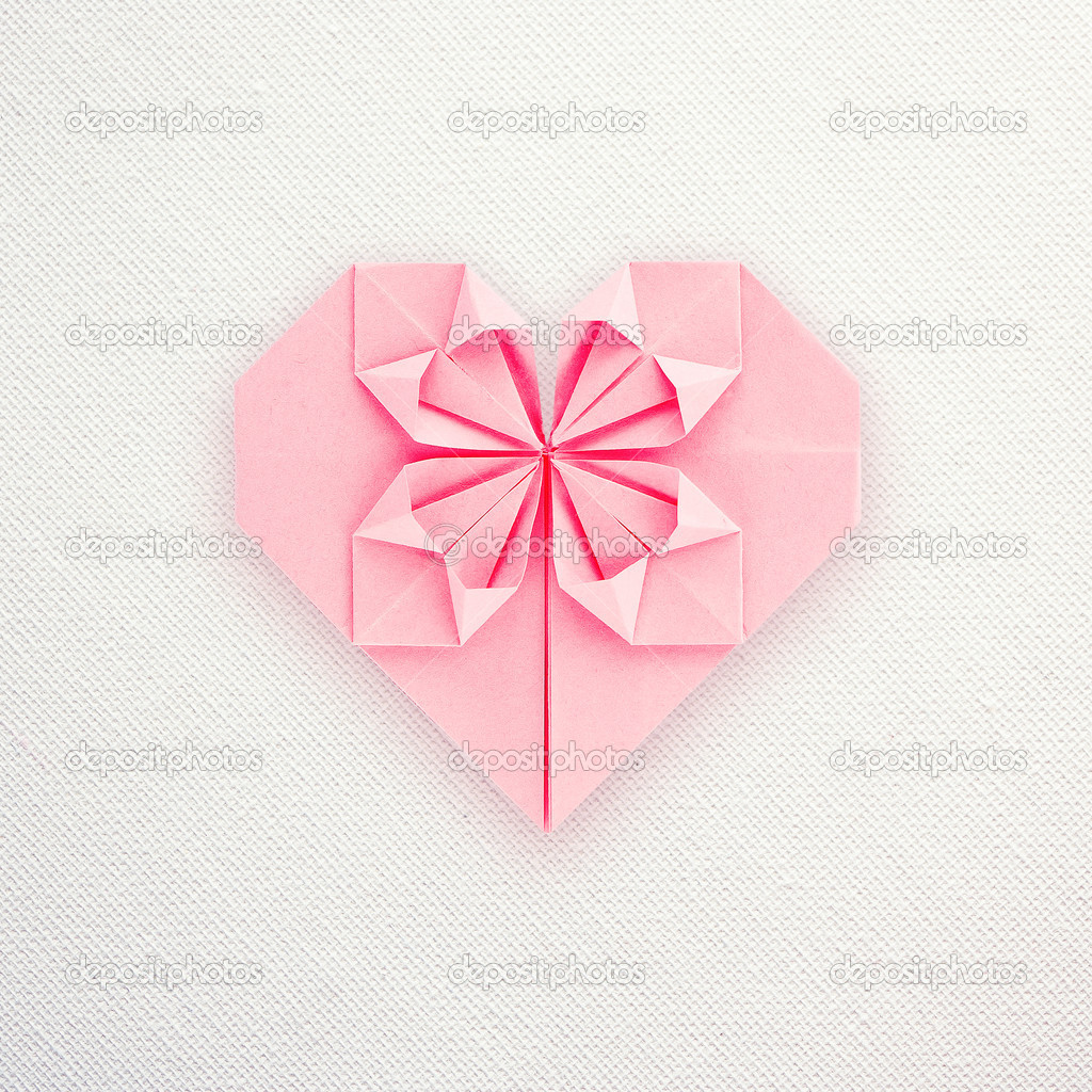 A Pink Paper Origami Heart On White Canvas Background