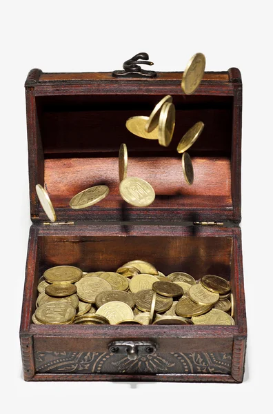 Coins in the air and in a box — Stock Photo, Image