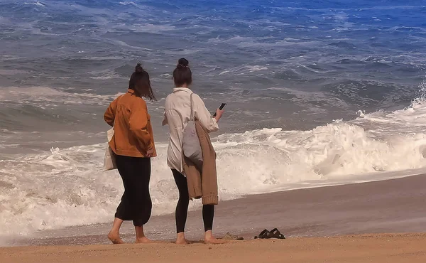 People by the ocean admiring the waves